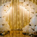 Decorated arch for wedding ceremony. White balloons, candles, autumn leaves and small pumpkins. A