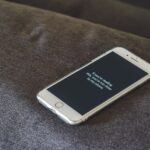 Google sanctionné pour le traitement de ses données de localisation : ce que change l’amende de 403 millions d’euros A smartphone with a humorous lock screen message placed on a grey couch, emphasizing privacy.