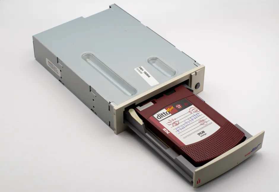 A vintage DittoMax tape drive showcasing an inserted 7GB cartridge.