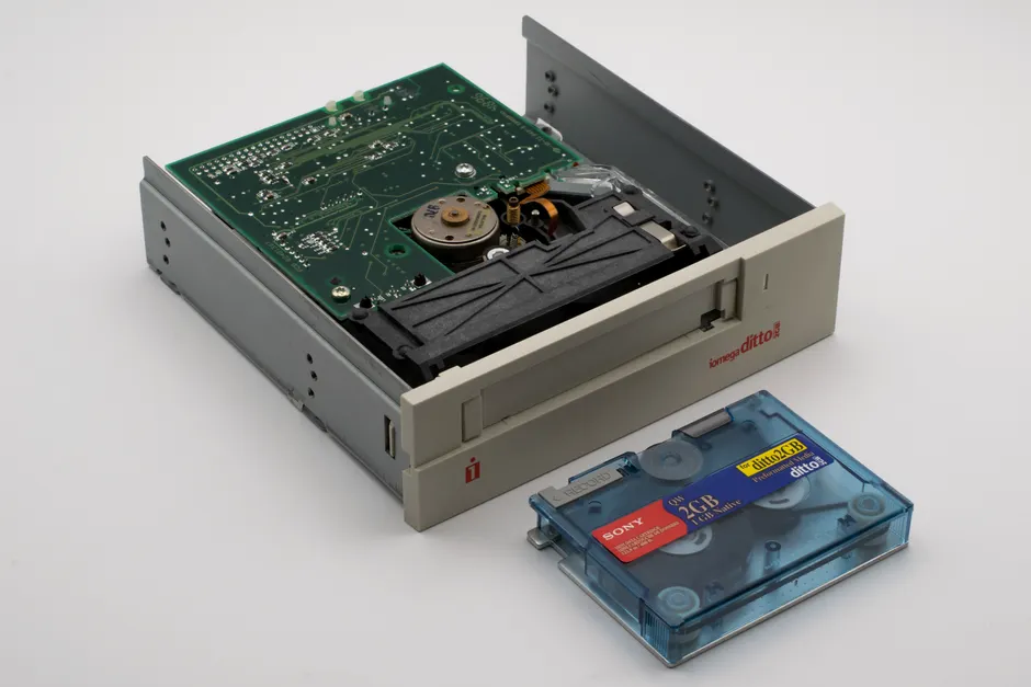 Close-up of a vintage Iomega Ditto internal tape drive with a blue Sony data cartridge, ideal for retro technology themes.