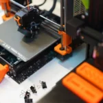 Detailed view of a 3D printer in a modern industrial setting, showcasing technology and creativity.