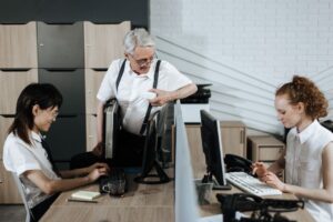 Group of diverse office workers collaborating at their desks. Professional teamwork setting.