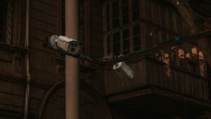 Street security cameras mounted on a pole in an urban environment, highlighting surveillance.