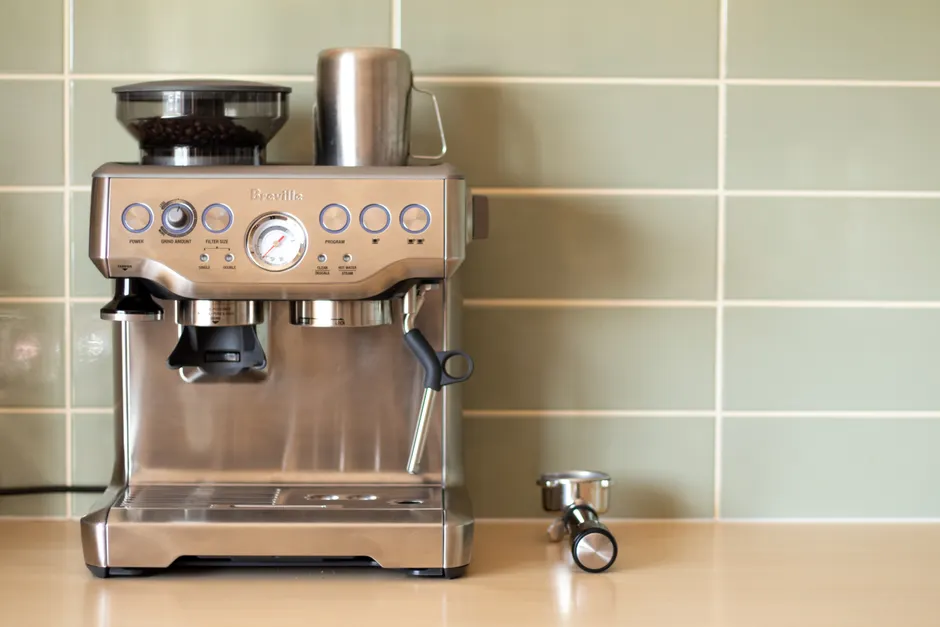 Modern espresso machine with push buttons and gauge, blending technology and convenience in a stylish kitchen setting.